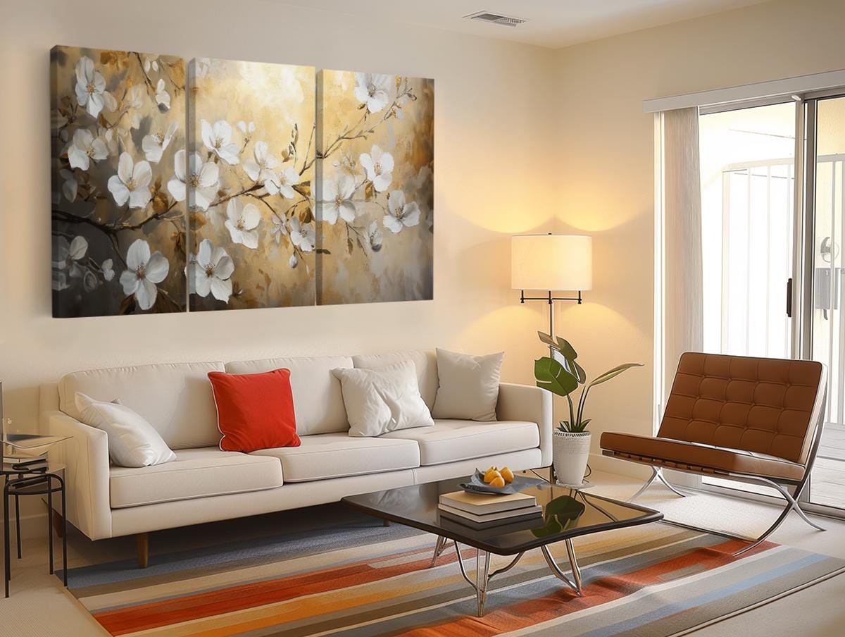a living room with a white couch and a painting on the wall