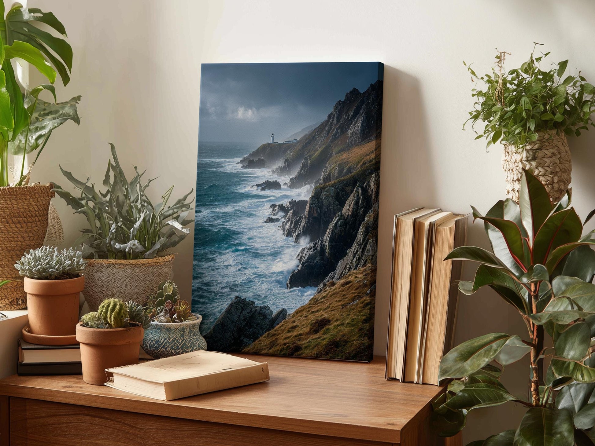 a wooden desk with a framed photograph of a coastal landscape, including a lighthouse, ocean waves, and rocky cliffs. The desk also has several potted plants, books, and other decorative items.