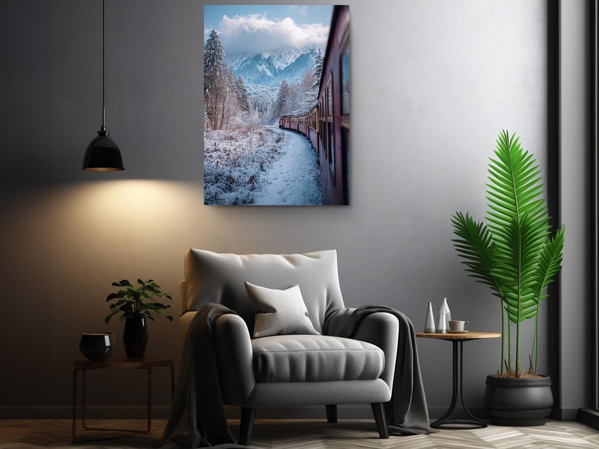 a cozy living room with a comfortable gray armchair, a small side table, and a potted plant. Above the armchair, there is a framed photograph of a snowy mountain landscape with a train passing through the snowy scenery.