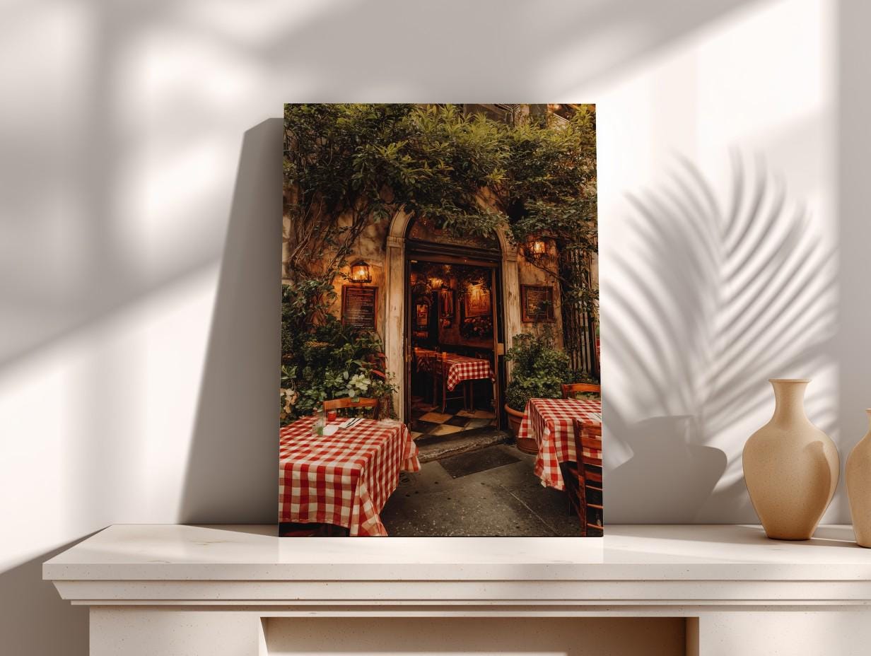 a cozy outdoor dining area with red and white checkered tablecloths, surrounded by lush greenery and illuminated by warm lighting.