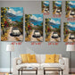 The image is a living room with a white sofa and a coffee table. Above the sofa, there are six framed pictures of a scenic coastal road with cars and buildings, each with a different size and resolution. The pictures are arranged in a grid-like pattern on the wall, creating a visually appealing display.