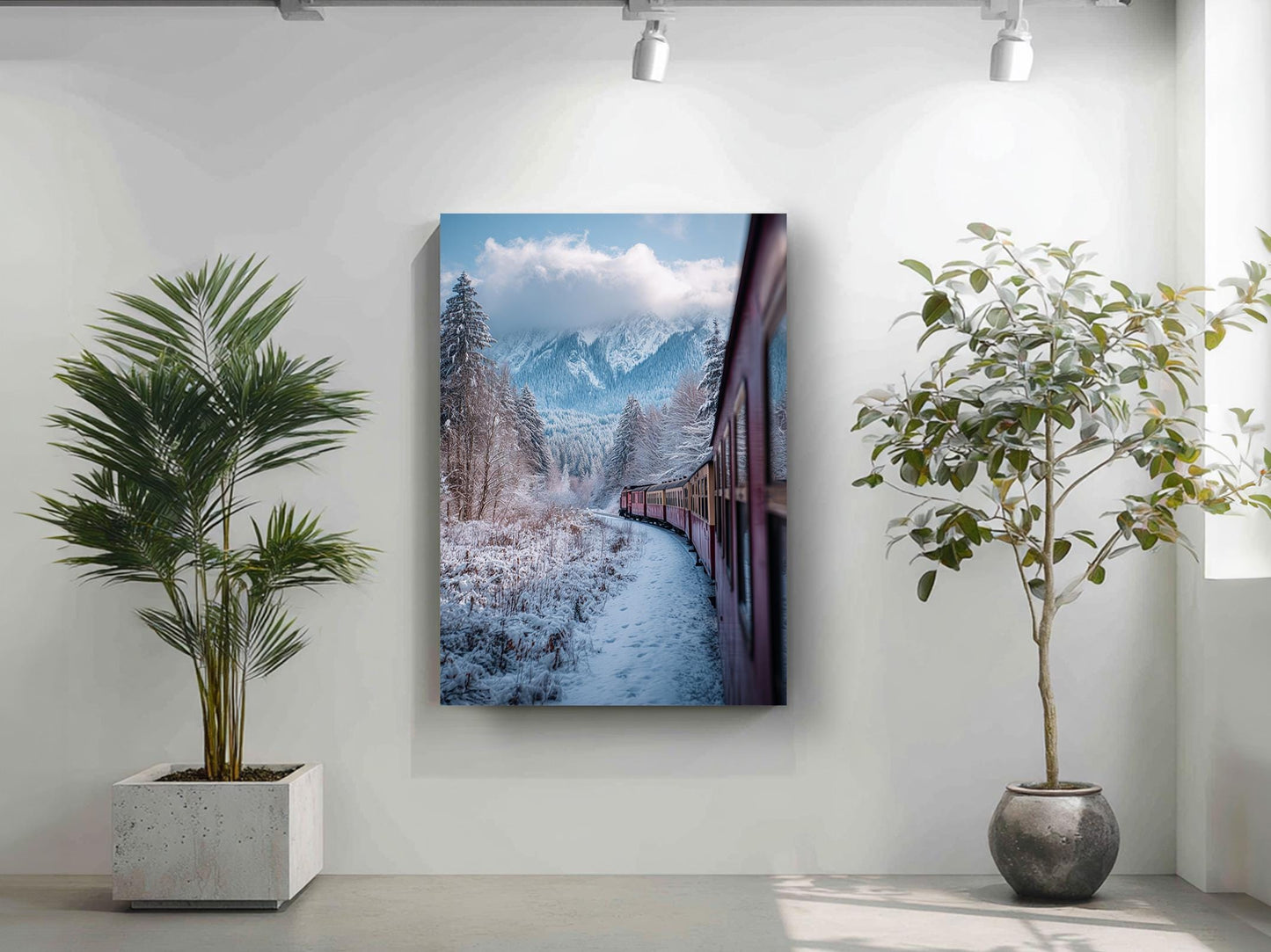 a snowy mountain landscape with a train traveling through it, as depicted in a framed artwork hanging on a wall.