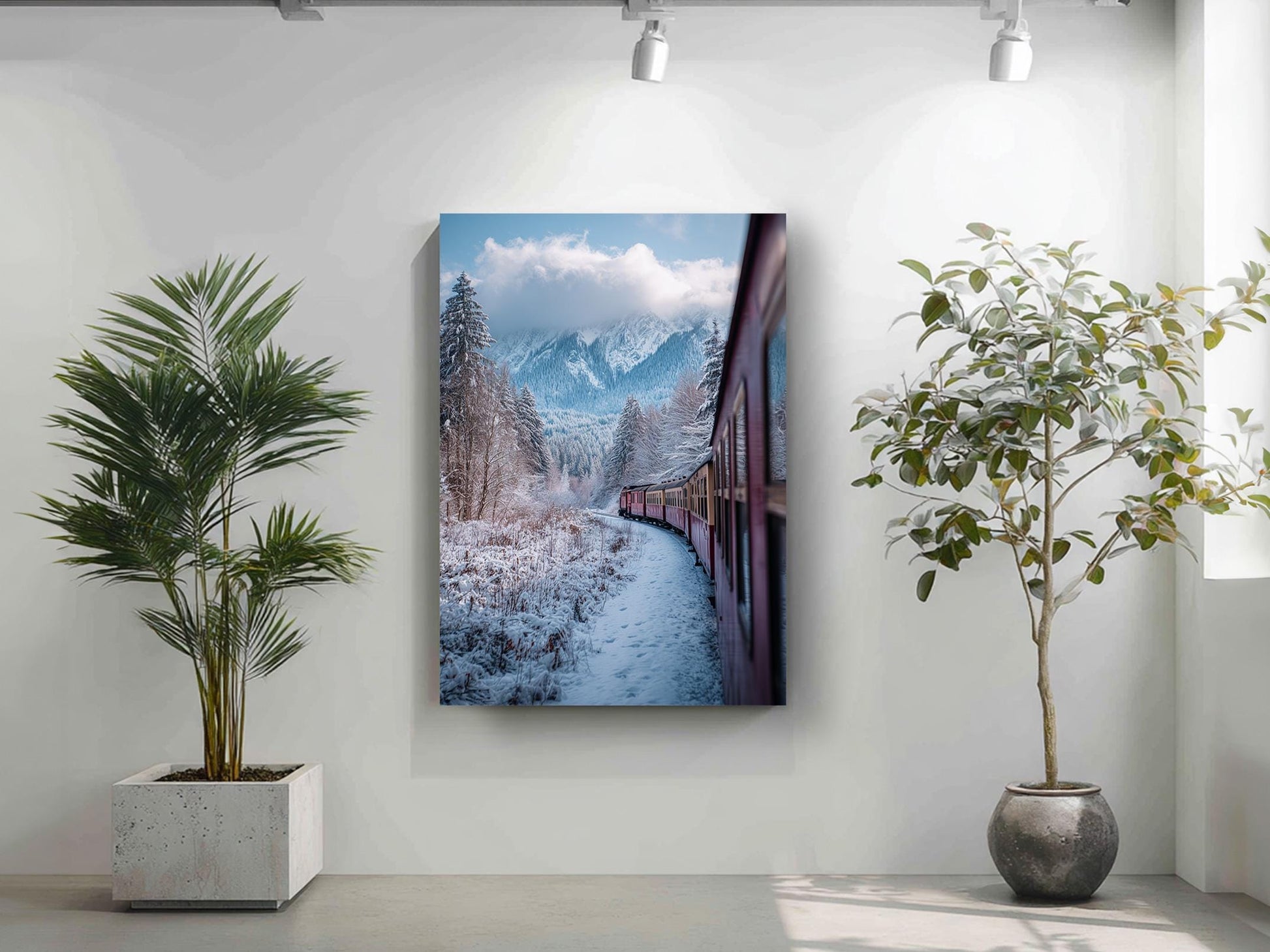 a snowy mountain landscape with a train traveling through it, as depicted in a framed artwork hanging on a wall.