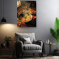 a cozy living room with a comfortable gray armchair, a wooden side table, and a potted plant. Above the armchair, there is a framed photograph of a bowl of ramen noodles with various toppings, including egg and meat, creating a warm and inviting atmosphere.