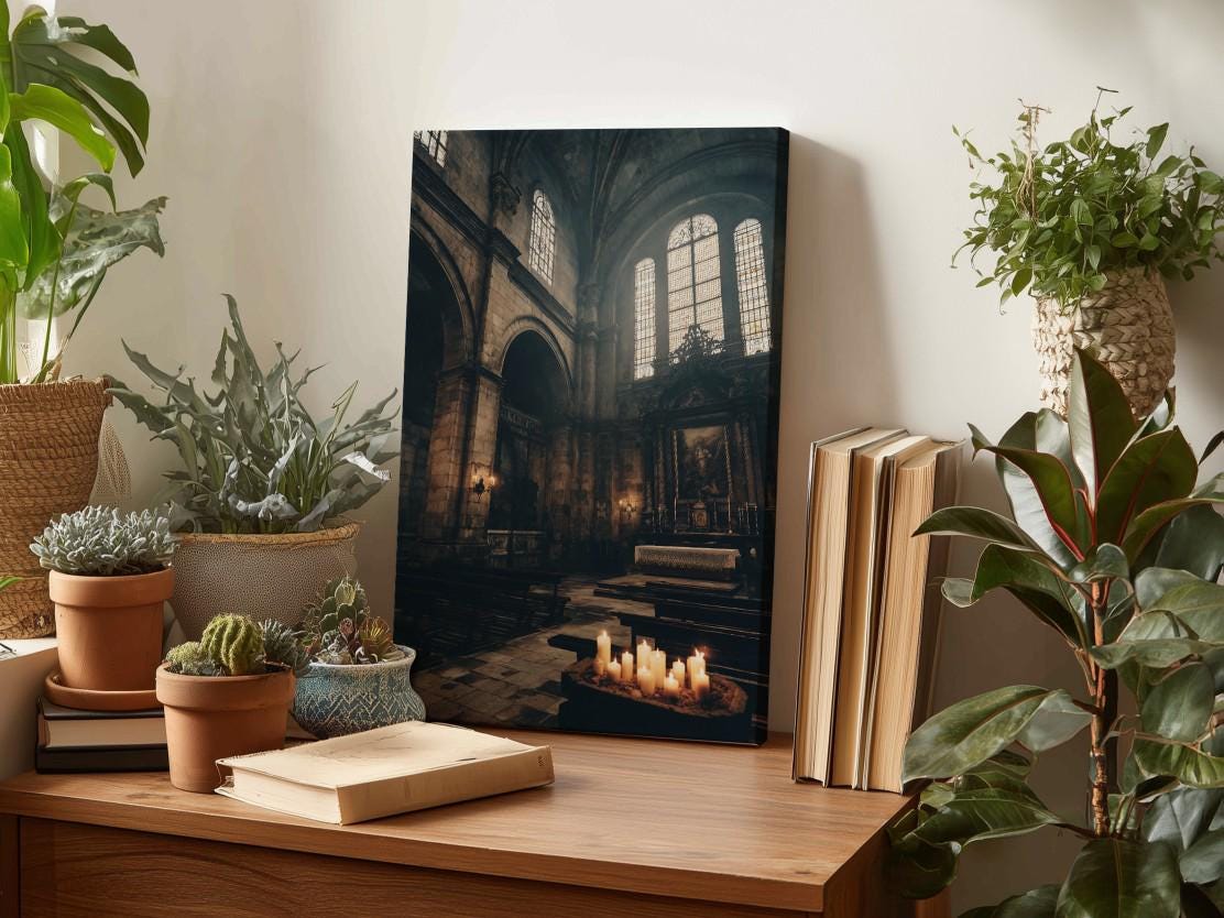 a wooden desk with a framed photograph of a church interior, surrounded by various potted plants and books.