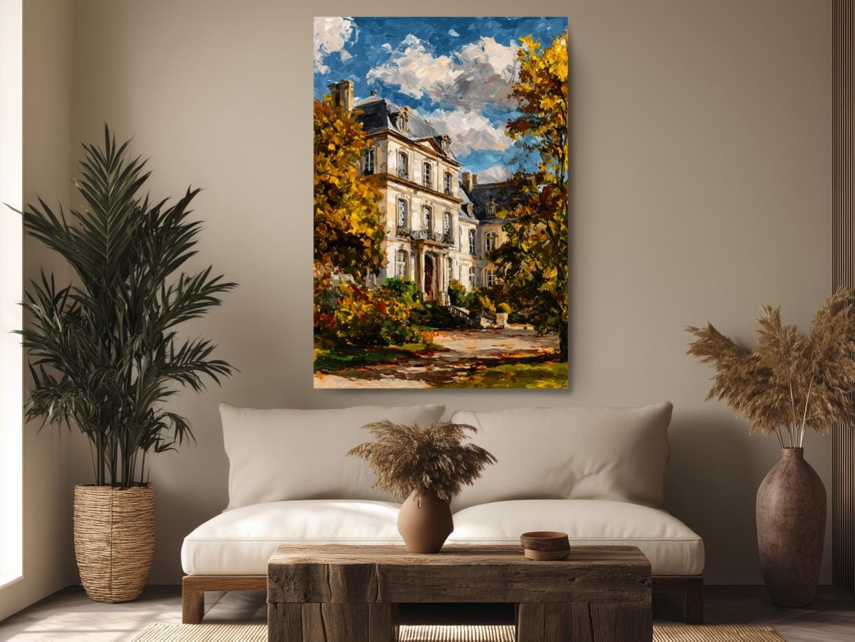 a large painting of a white house with a blue roof, surrounded by trees and a path, hanging on a wall above a couch and a coffee table in a living room setting.