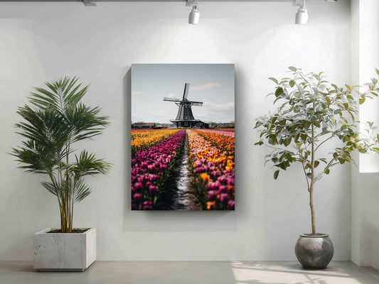 a large painting of a windmill in a field of colorful tulips hanging on a white wall.