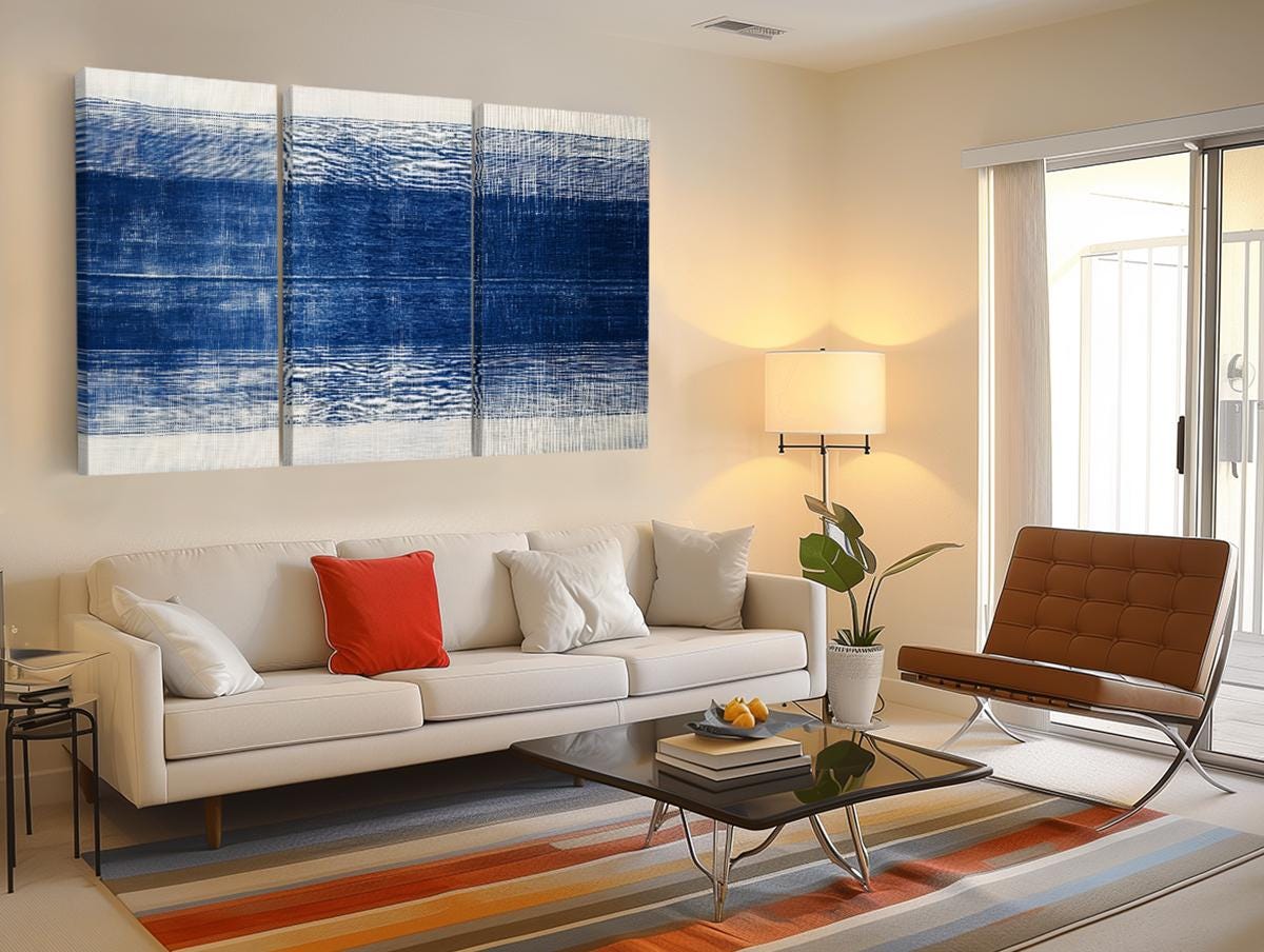 a living room filled with furniture and a painting on the wall