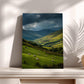 a serene countryside scene with a group of sheep grazing in a lush green field, set against a backdrop of rolling hills and a dramatic cloudy sky.