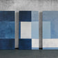 three blue and white paintings on a wall