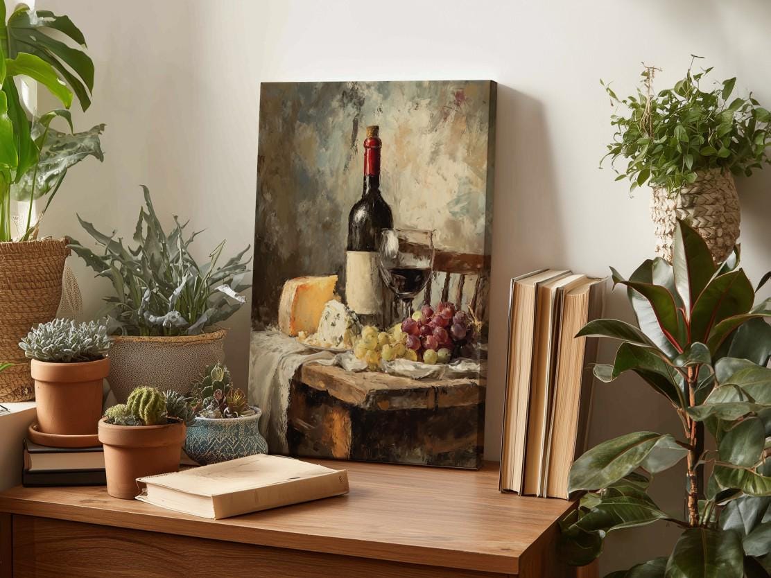 a wooden table with a painting of a wine bottle and various fruits, such as grapes and cheese, as well as some books and potted plants.