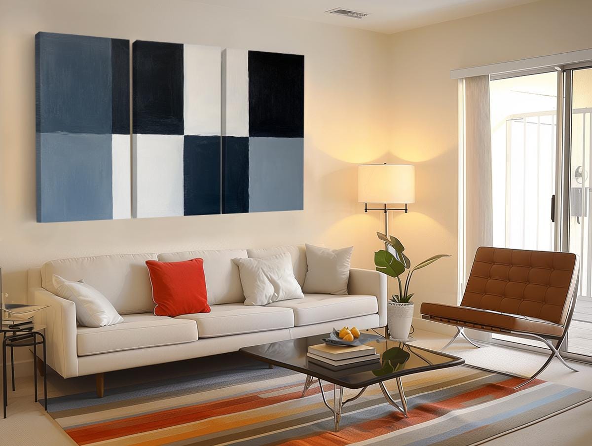 a living room filled with furniture and a painting on the wall