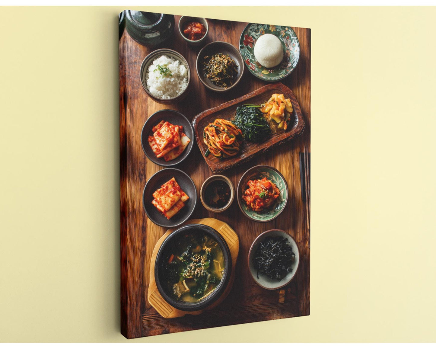 A wooden table is set with a variety of Asian dishes, including rice, vegetables, and sauces, arranged in an appealing manner.