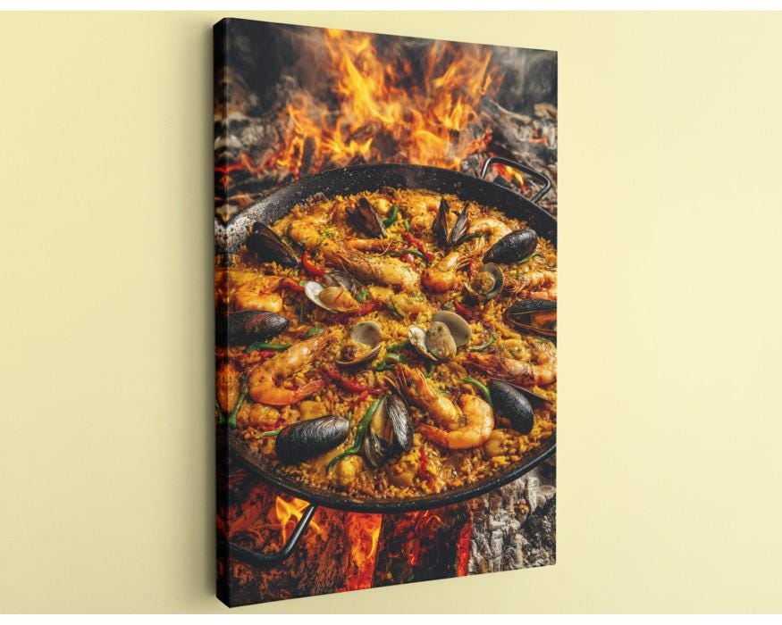 A close-up of a paella dish with shrimp, mussels, and other seafood, cooked over a fire.