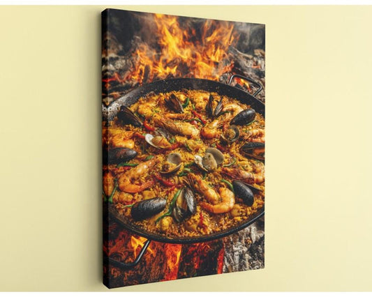 A close-up of a paella dish with shrimp, mussels, and other seafood, cooked over a fire.