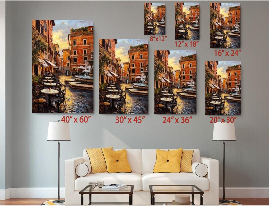 The image is a living room with a white sofa and a coffee table. Above the sofa, there are six framed paintings of a city street scene, each with a different size and resolution. The paintings are arranged in a grid-like pattern on the wall, with each one depicting a different view of the city street. The wall also has a lamp on each side, providing lighting for the room.