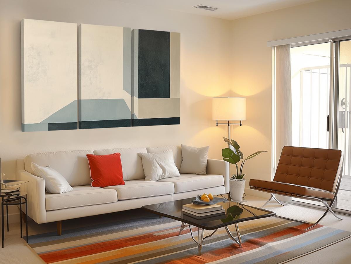 a living room filled with furniture and a painting on the wall