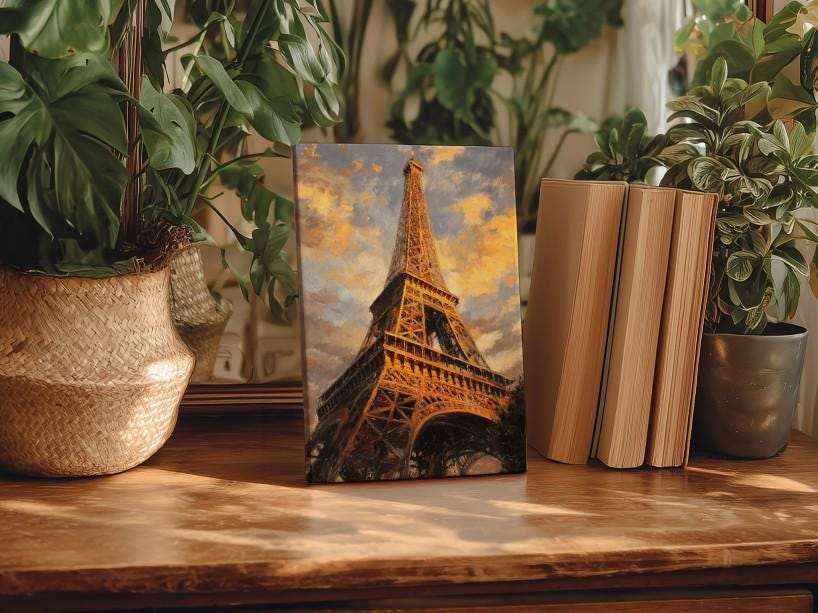 a wooden table with a framed painting of the Eiffel Tower in the center, surrounded by potted plants and books.