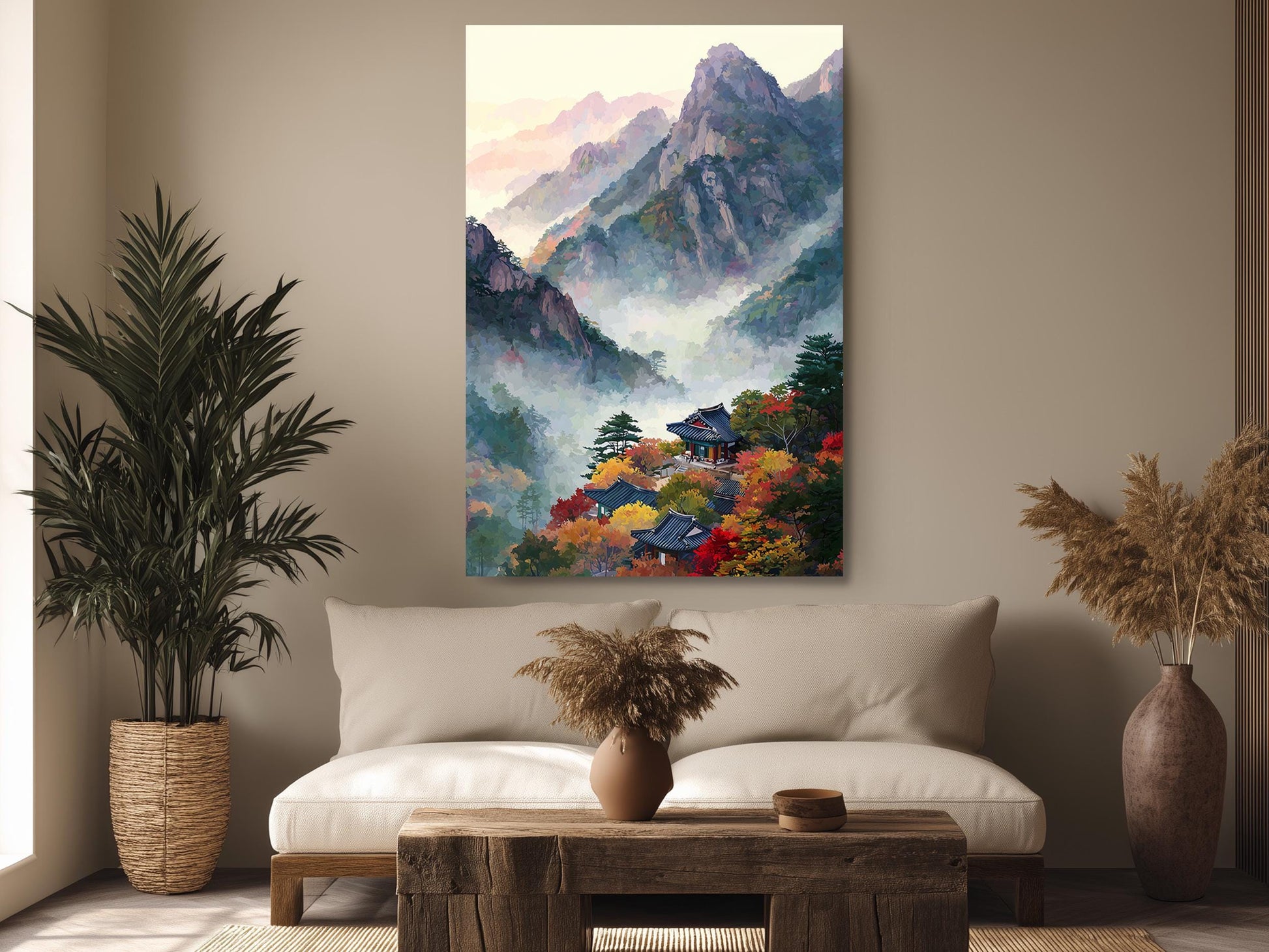 a living room with a large painting of a mountainous landscape hanging on the wall above a couch. The painting depicts a serene mountain scene with colorful autumn foliage. The room is decorated with potted plants, a vase, and a wooden coffee table.