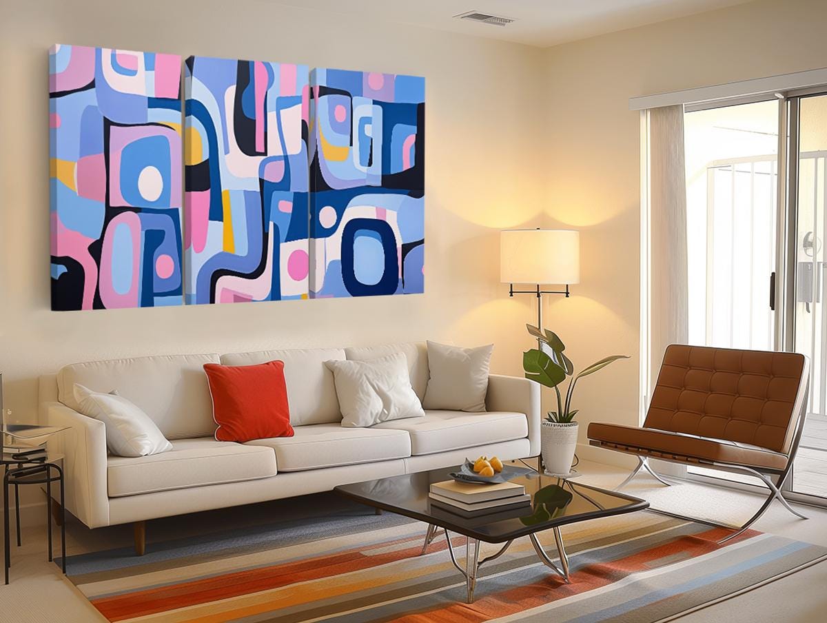 a living room filled with furniture and a painting on the wall