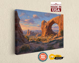 The image is a painting of a desert landscape with rock formations and a sunset sky.