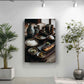 a wall with a large framed photograph of a table set with various dishes, including bowls of rice, a plate of food, and a vase. The photograph is surrounded by potted plants, creating a serene and inviting atmosphere.