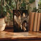 a wooden table with a framed photograph of an old building, surrounded by potted plants and books.