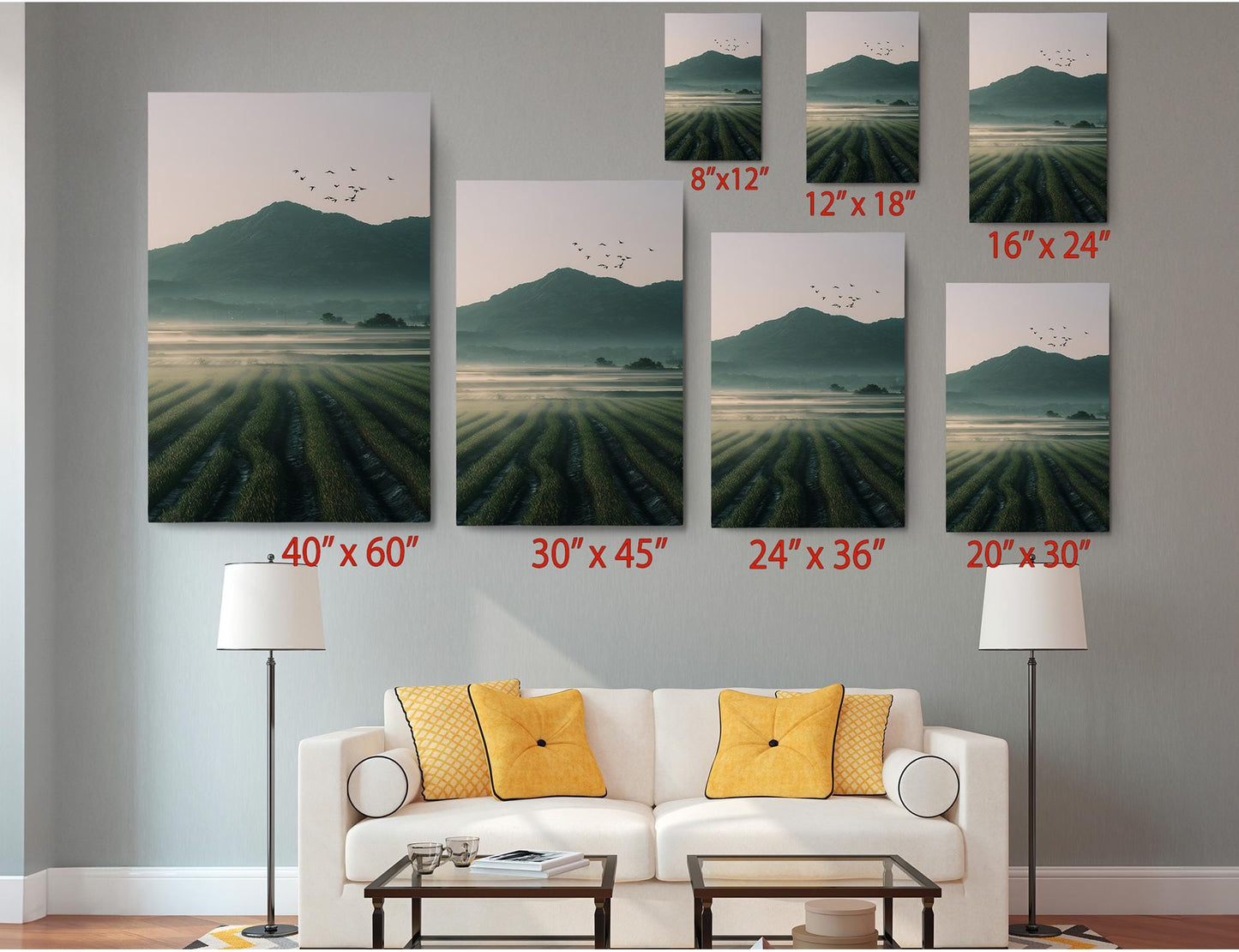 The image is a living room with a white sofa and a coffee table. Above the sofa, there are six framed landscape paintings of varying sizes, each depicting a different landscape scene. The paintings are arranged in a grid-like pattern on the wall, with each one showing a different perspective of the same landscape.