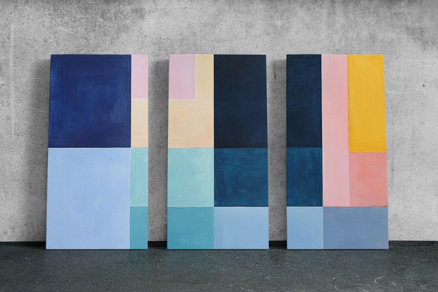 a group of three paintings sitting on top of a cement floor
