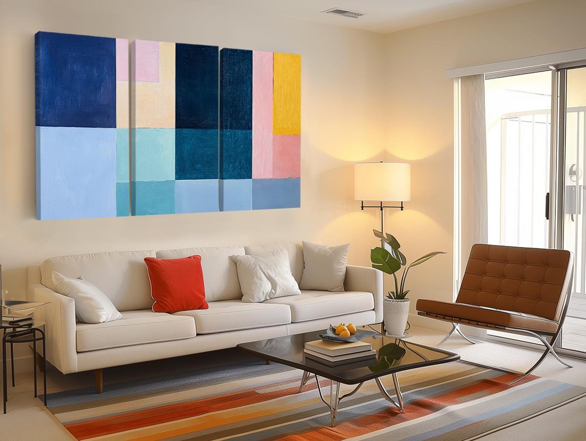 a living room filled with furniture and a painting on the wall