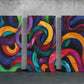 three paintings of different colors on a wall