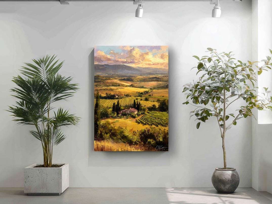a large landscape painting hanging on a wall, with a potted plant to the left and a potted plant to the right.