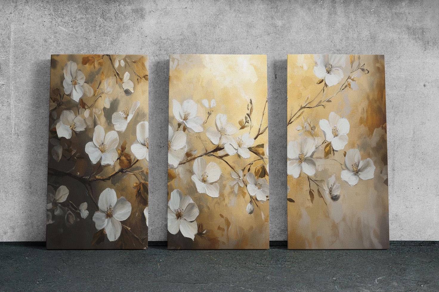 three paintings of white flowers on a wall