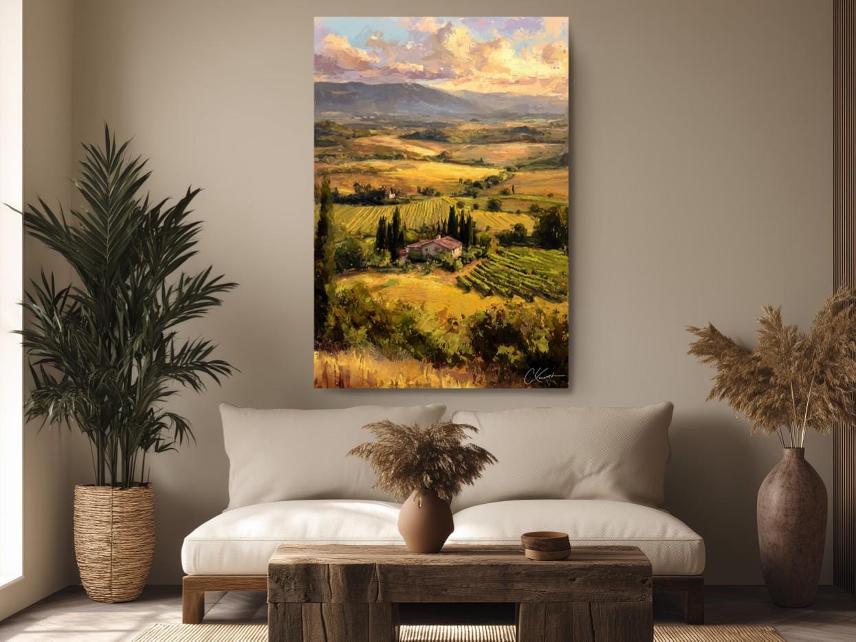 a large painting of a countryside landscape hanging on a wall above a couch in a living room.