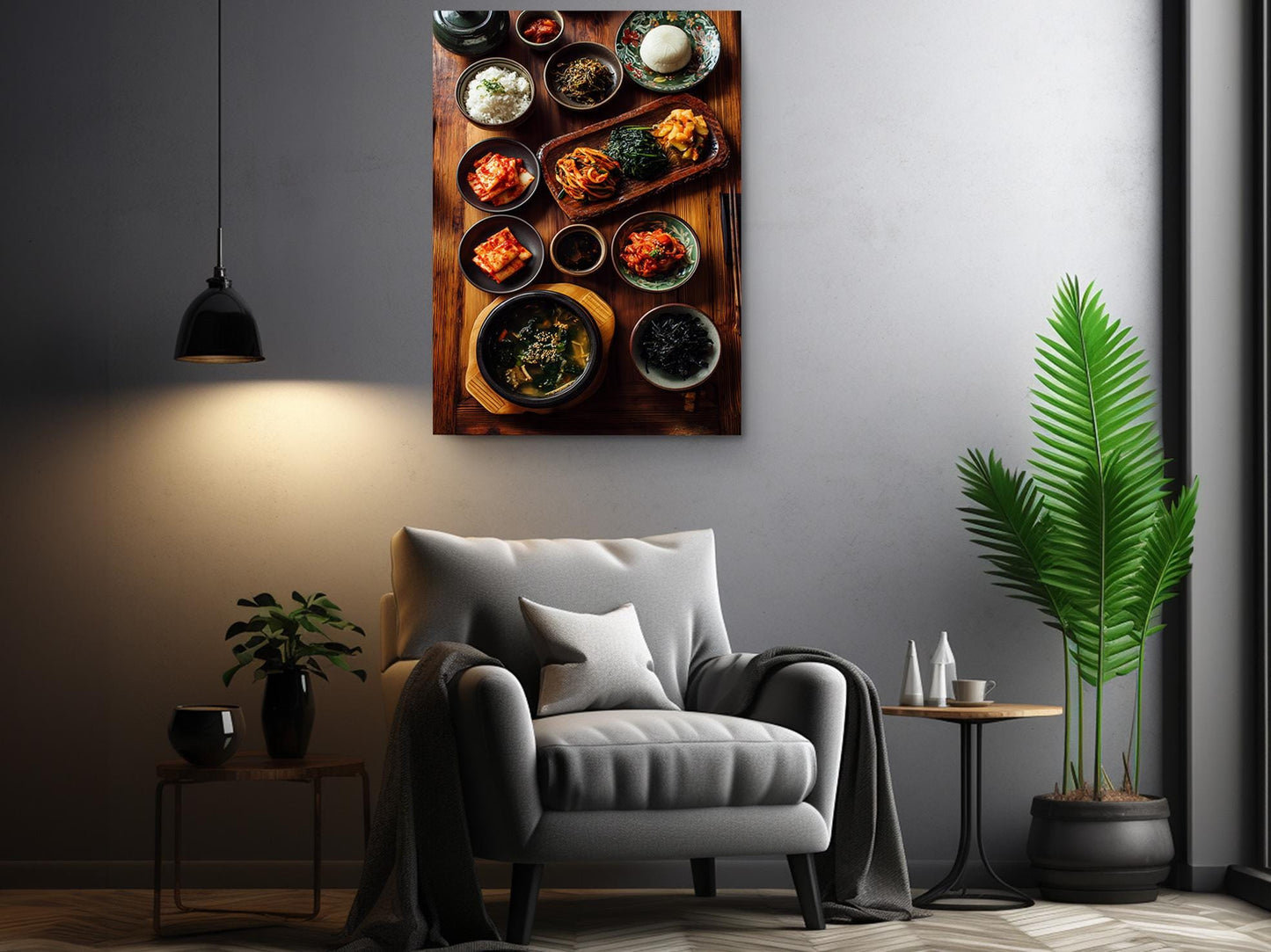 a cozy living room with a comfortable gray armchair, a wooden side table, and a potted plant. Above the armchair, there is a large framed picture of various bowls and dishes filled with food, creating a warm and inviting atmosphere.