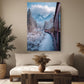 a cozy living room with a large window, a comfortable couch, and a wooden coffee table. Above the couch, there is a framed photograph of a train traveling through a snowy mountain landscape, with a clear blue sky and fluffy white clouds in the background.