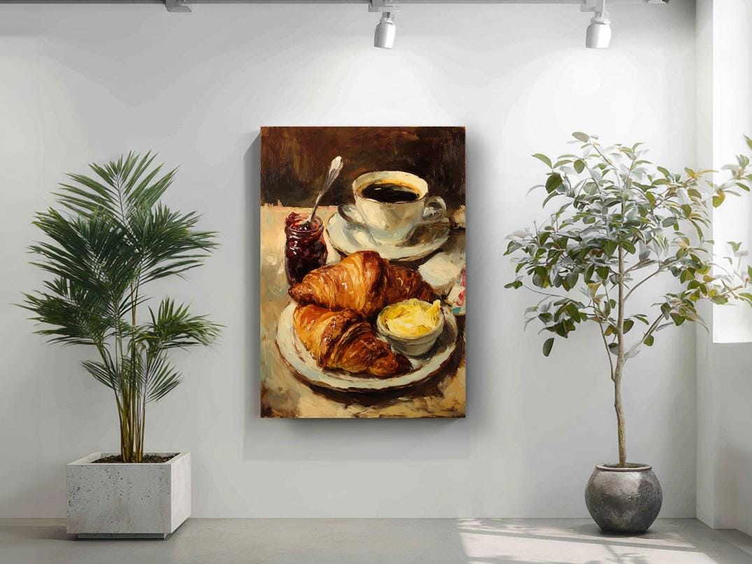 a painting of a breakfast scene with a croissant, butter, and jam on a plate, displayed on a wall in a room with two potted plants.