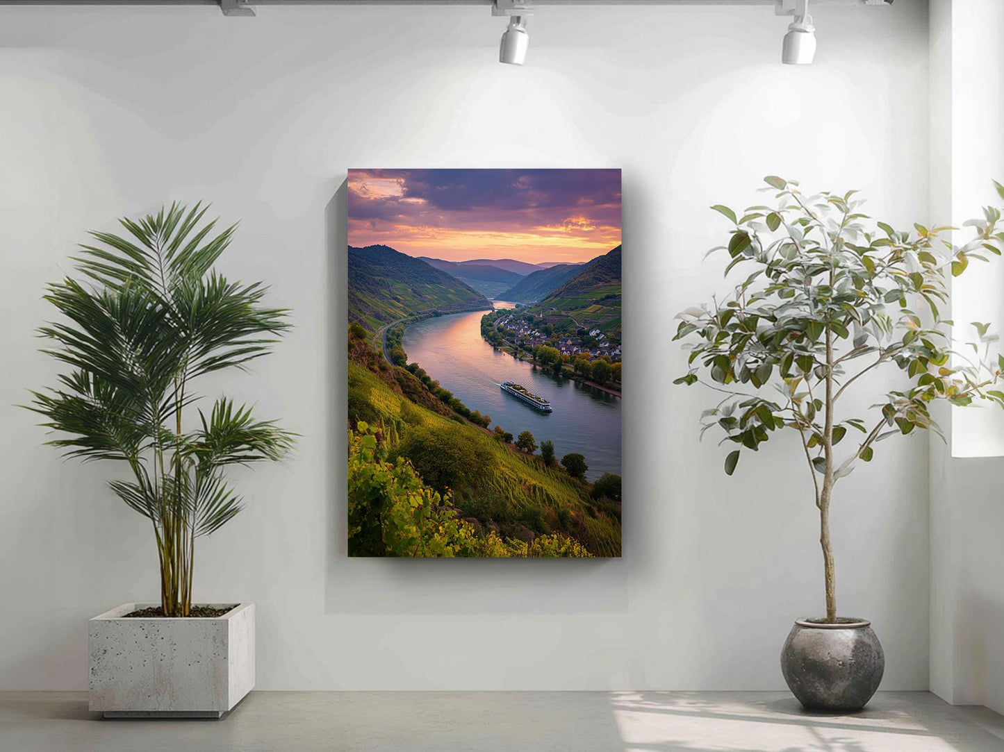 a large landscape painting depicting a serene river surrounded by mountains, with a boat floating on the water. The painting is hung on a white wall, and there are two potted plants in the foreground, one on the left and one on the right.