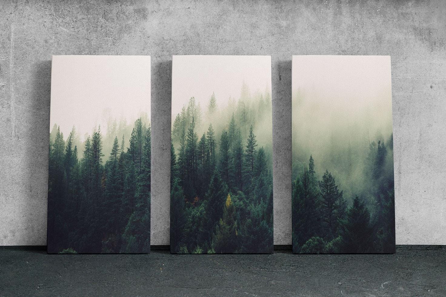 three paintings of trees on a concrete wall