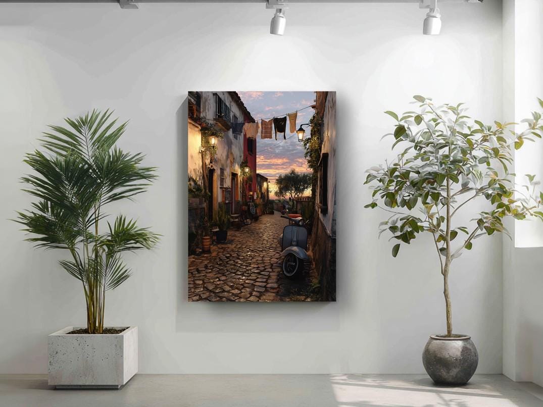 a cobblestone street lined with buildings and trees, with a colorful sunset sky in the background.