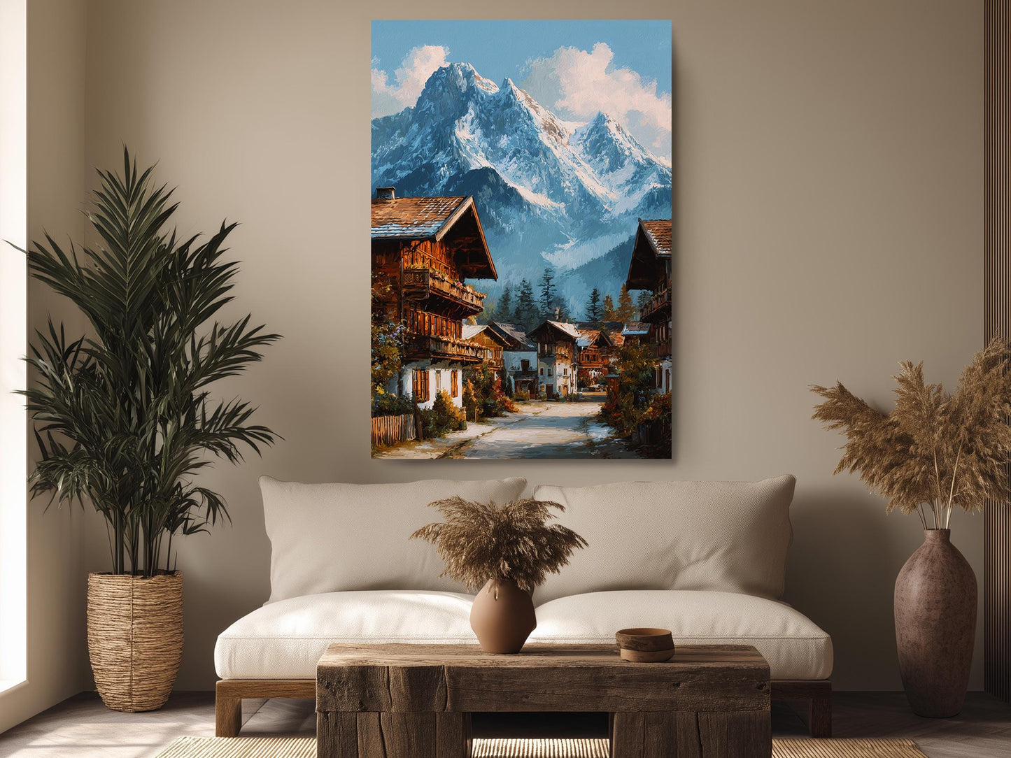 a cozy living room with a large painting of a picturesque mountain village hanging on the wall. The painting depicts a charming village nestled at the foot of a majestic mountain range, with colorful buildings and lush greenery surrounding the area. The room is decorated with potted plants, a wooden coffee table, and a comfortable couch, creating a warm and inviting atmosphere.