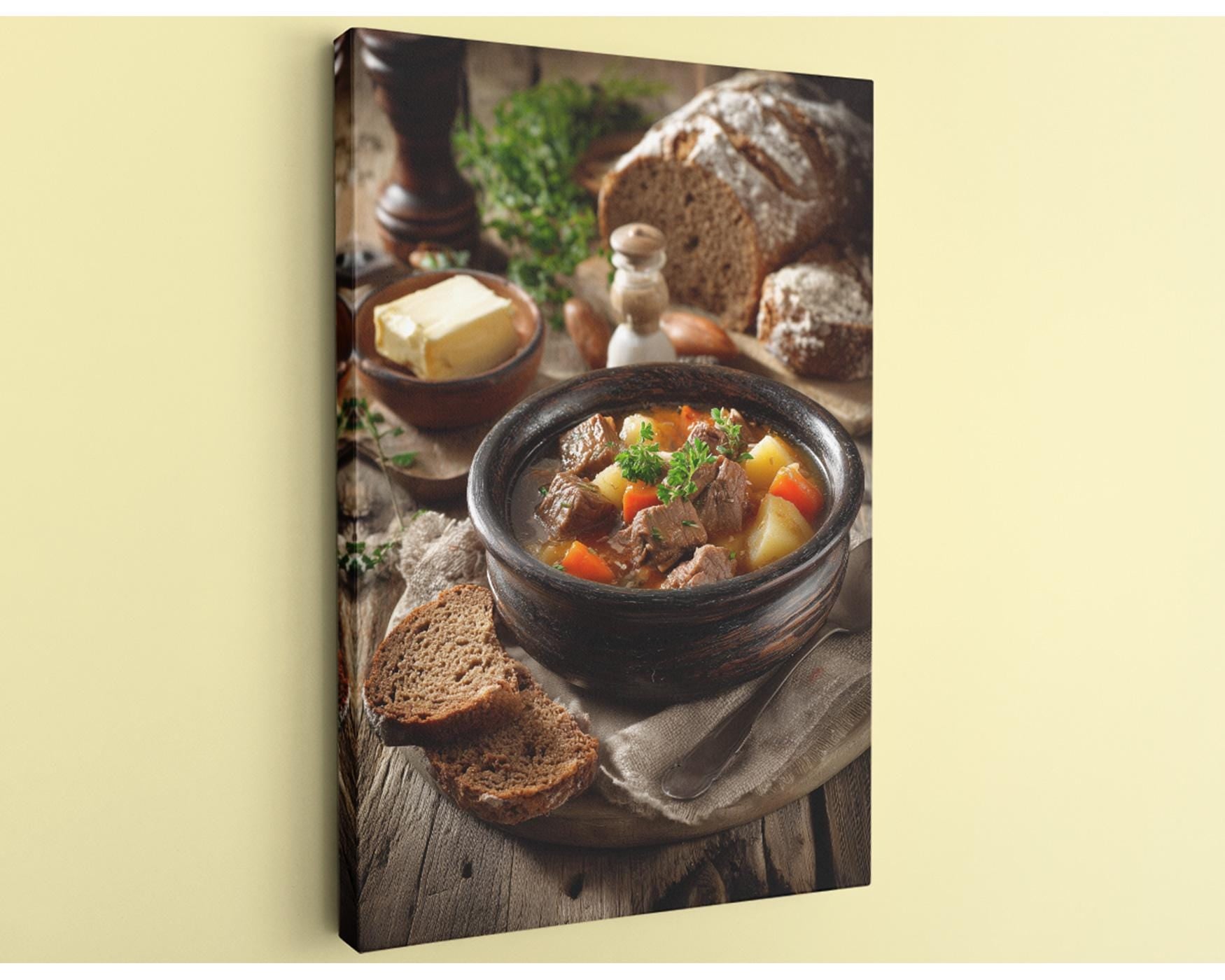 A hearty stew in a bowl, accompanied by a loaf of bread and a variety of vegetables, is the focal point of the image.