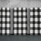 three black and white checkered paintings on a wall
