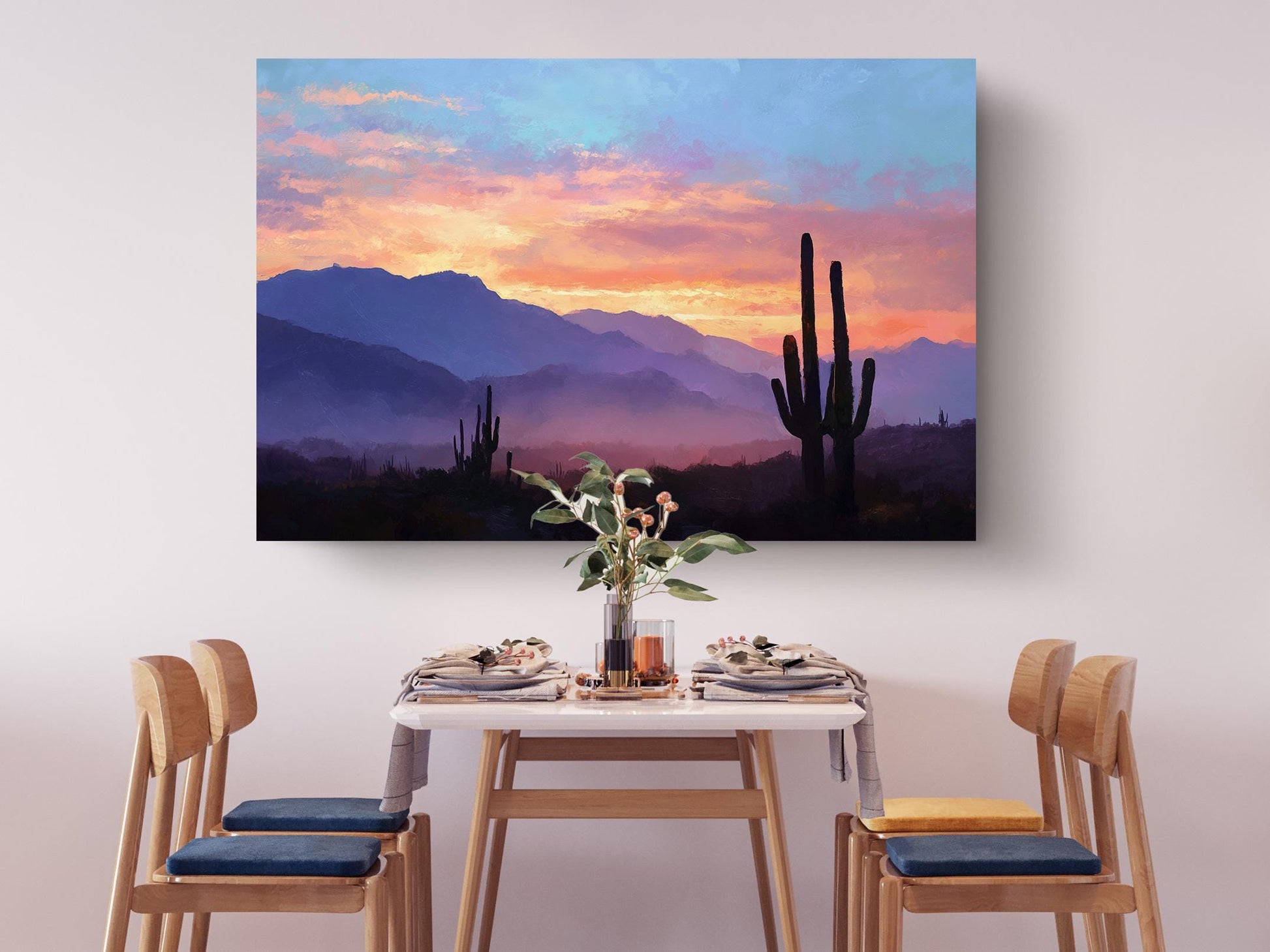 a serene dining scene with a table set for four, featuring a vase of flowers and a painting of a desert landscape with mountains in the background.