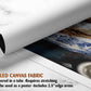 The image is a rolled canvas fabric, which is a type of canvas material used for painting or printing. It is described as a tube-delivered fabric that requires stretching and can be used as a poster with a 2.5&quot; edge area.