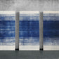 three blue and white paintings on a wall