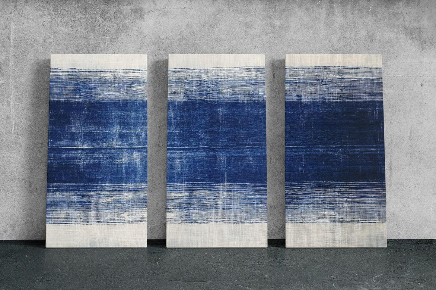 three blue and white paintings on a wall