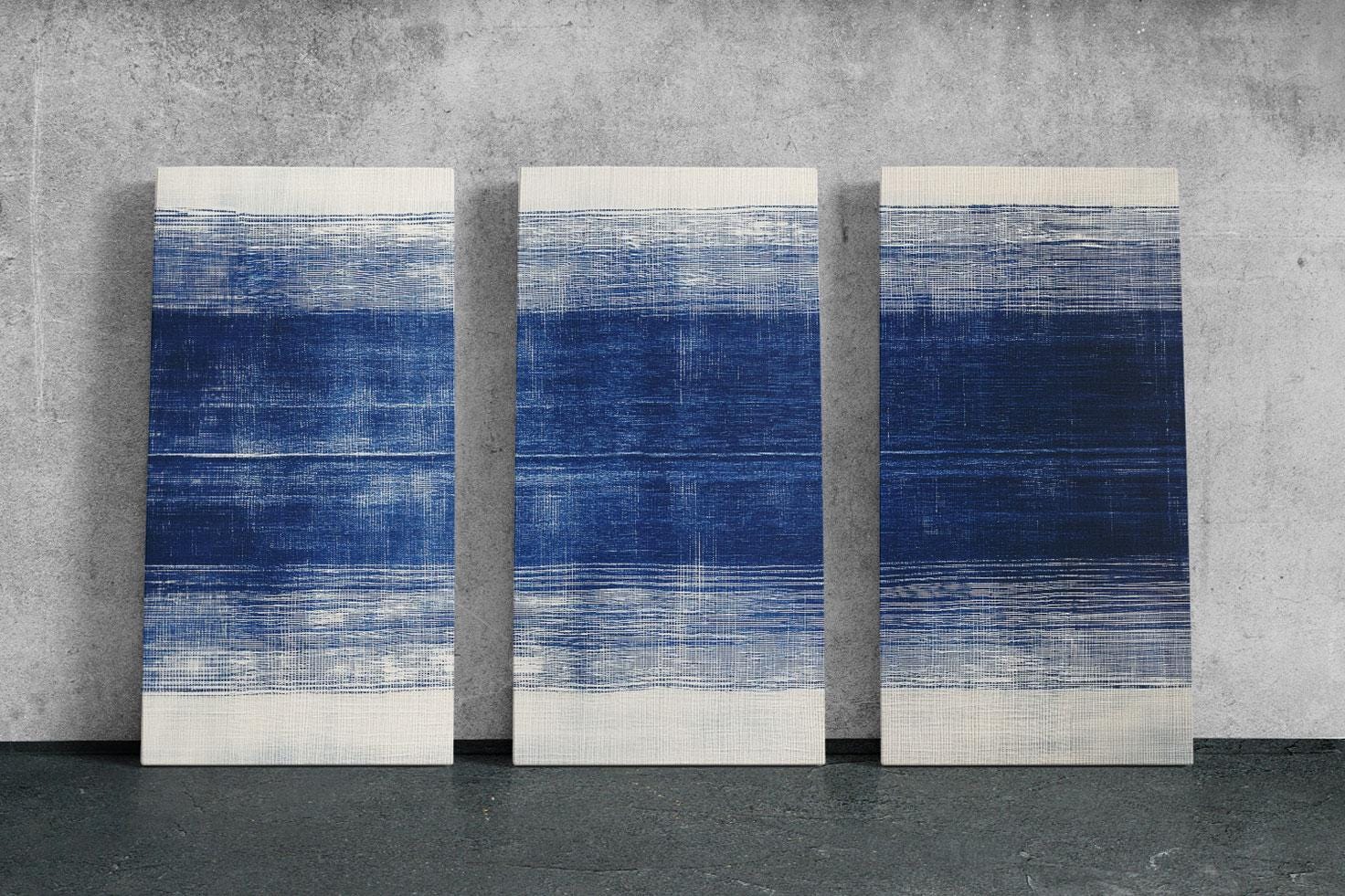 three blue and white paintings on a wall