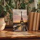 a framed painting of the Eiffel Tower in Paris, surrounded by potted plants and books on a wooden surface.