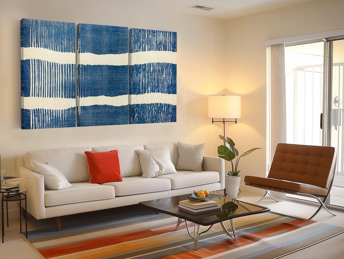 a living room filled with furniture and a painting on the wall